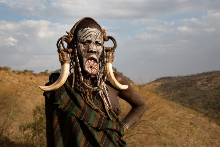 Ethiopia Suri Tribe mum with lip plate and face painting